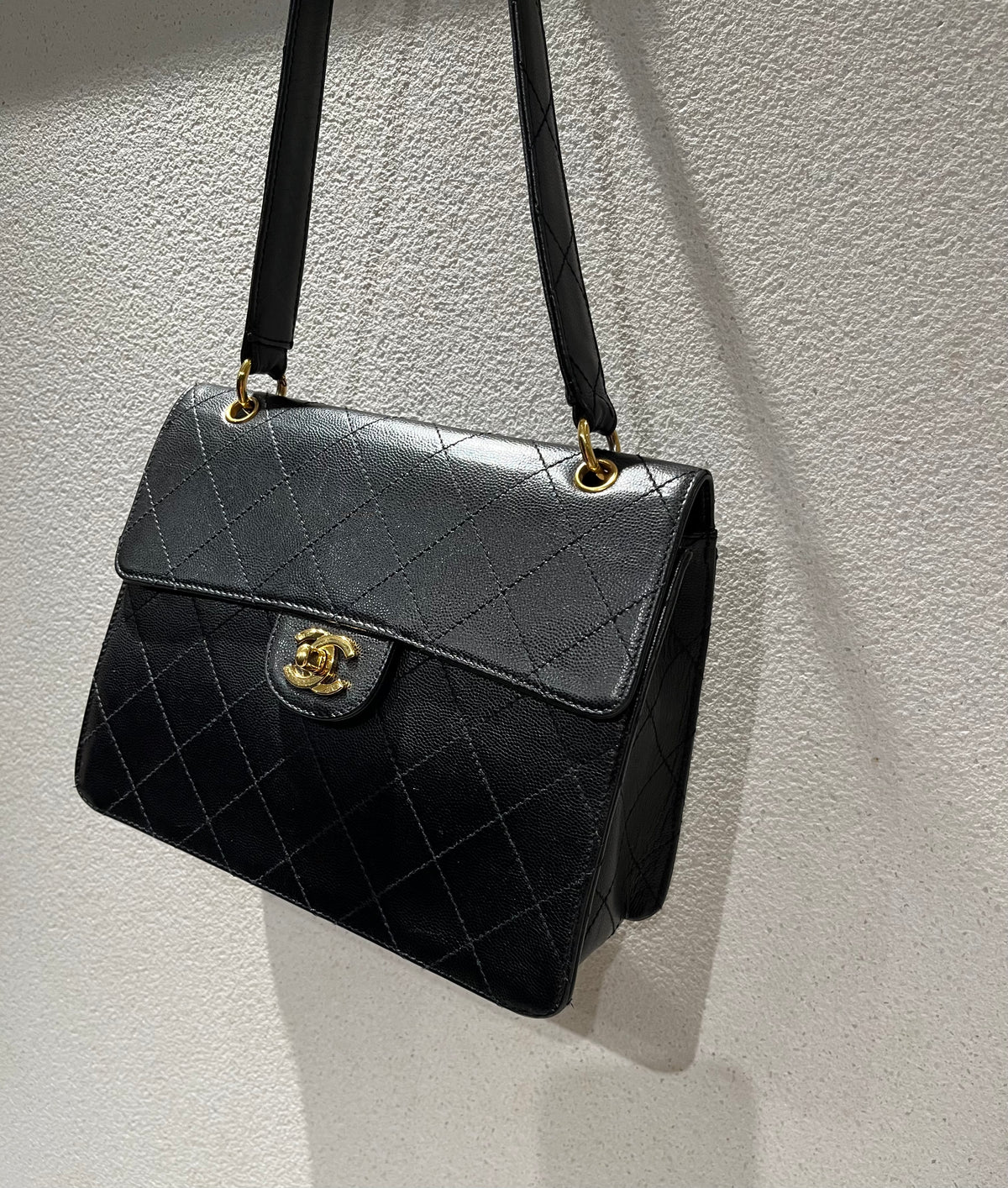 Featuring a vintage Chanel black caviar Kelly shoulder bag