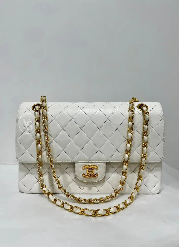 Front view of a vintage Chanel white lambskin Classic Double Flap bag with 24k gold-plated CC turn-lock and chain strap